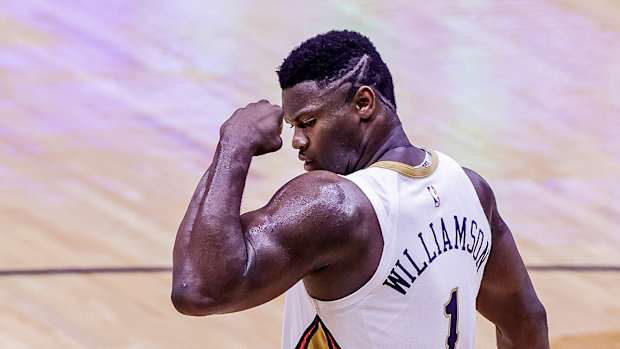 Zion Williamson flexes after making a shot.